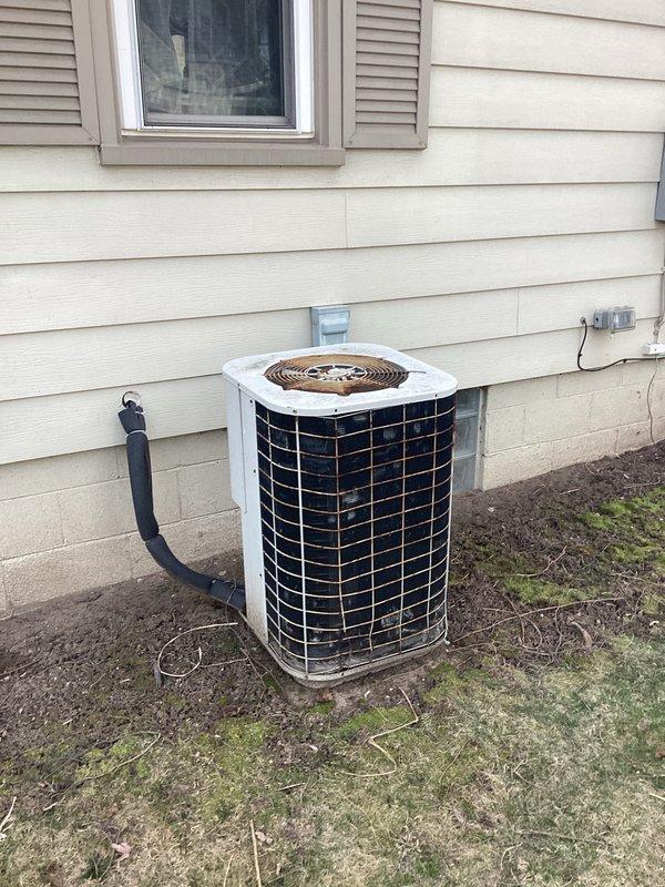 Completed comprehensive estimate for full HVAC system replacement at residential property where existing air conditioning unit has exceeded its service life, showing significant rust and deterioration despite operating through previous cooling season. Assessed both indoor furnace installation in basement utility area and outdoor condensing unit positioned against home exterior, documented current system configuration including ductwork and condensate management components, and provided replacement options for aging equipment to ensure reliable climate control performance.