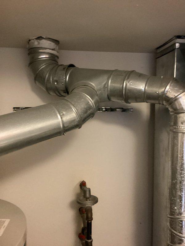 Completed comprehensive HVAC system replacement estimate for aging residential equipment (9-11 years old). Assessed existing furnace, air handler, and associated ductwork configuration in utility space, documenting current installation including metallic flexible duct connections, PVC condensate drainage lines, refrigerant line routing with insulation, and existing duct distribution system with branching configuration and pressure regulation components.