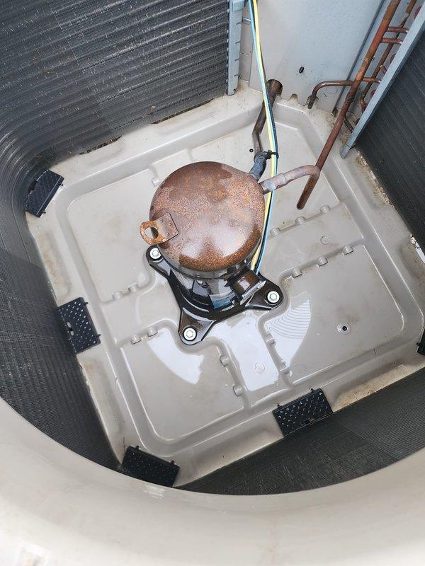 Completed prepaid HVAC maintenance service on residential air conditioning system. Performed comprehensive AC tune-up including inspection of indoor evaporator coil assembly, compressor unit with visible oxidation on dome casing, refrigerant lines, and condensate drain pan. Evaluated outdoor condenser unit with protective cylindrical grille and verified proper mounting on concrete pad. All components operational and system functioning within normal parameters at time of service completion.