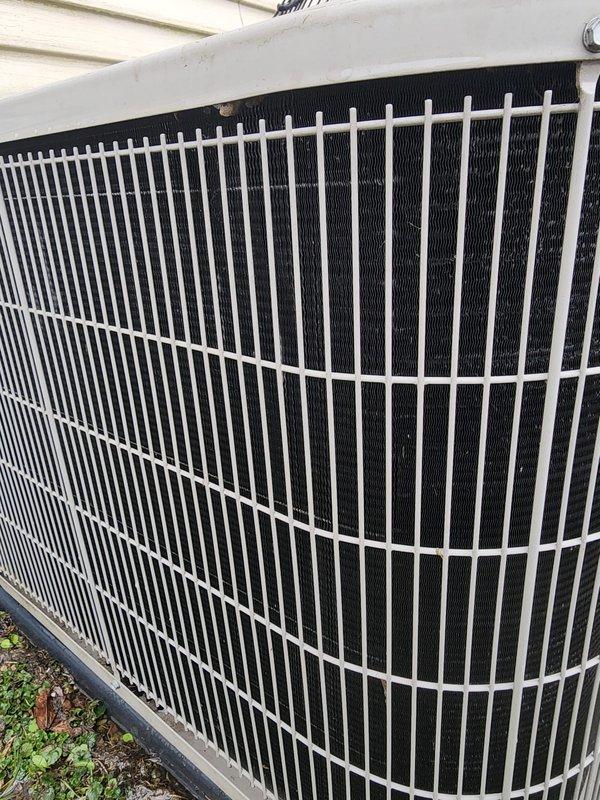 Completed prepaid HVAC maintenance service on residential air conditioning system. Performed comprehensive AC tune-up including inspection of indoor evaporator coil assembly, compressor unit with visible oxidation on dome casing, refrigerant lines, and condensate drain pan. Evaluated outdoor condenser unit with protective cylindrical grille and verified proper mounting on concrete pad. All components operational and system functioning within normal parameters at time of service completion.