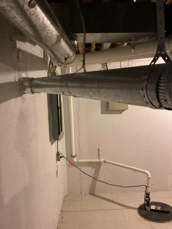 Conducted on-site assessment for water heater replacement in basement utility area. Evaluated existing water heater installation, surrounding infrastructure including overhead ductwork, PVC piping configuration, and electrical connections. Documented current equipment condition and spatial requirements for replacement unit, photographed installation area to provide comprehensive estimate for water heater upgrade.