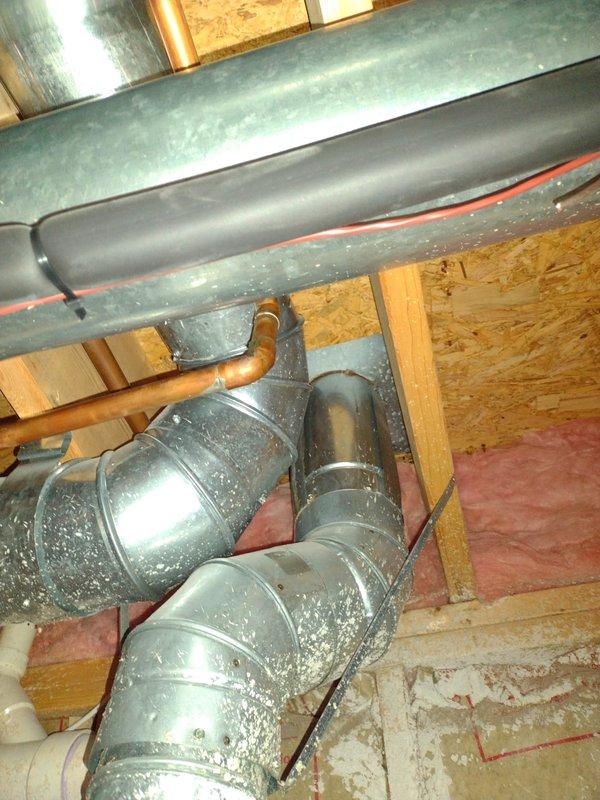 Completed installation of residential tanked water heater in basement utility area. Unit was positioned against wall with proper clearances maintained from HVAC equipment and ductwork, with all supply and discharge plumbing connections secured and tested for leaks. Installation meets code requirements for mechanical room placement and venting specifications.