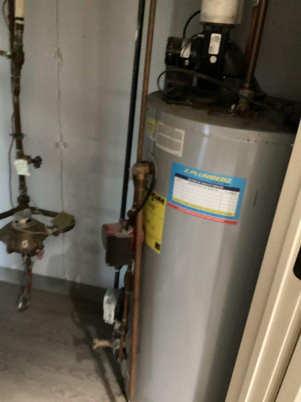 Provided estimate for replacement of non-functional 50-gallon power vent water heater for returning customer at new address. Assessed existing installation including copper supply lines, shut-off valves, top-mounted power vent assembly, and drainage system to determine replacement specifications and scope of work.