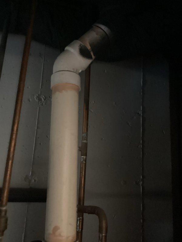 Provided estimate for replacement of non-functional 50-gallon power vent water heater for returning customer at new address. Assessed existing installation including copper supply lines, shut-off valves, top-mounted power vent assembly, and drainage system to determine replacement specifications and scope of work.