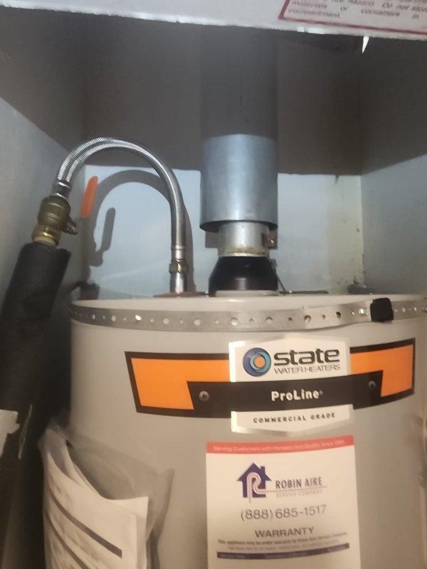 Completed installation of State ProLine Commercial Grade tanked water heater in mobile home utility closet. Removed existing unit and installed replacement water heater with proper clearances in confined space. Connected cold water inlet and hot water outlet lines using flexible copper connectors and installed appropriate shut-off valves for isolation capability. Installed temperature and pressure relief valve at top of unit with discharge piping. Connected vent pipe system at top of heater to ensure proper exhaust ventilation. Secured all plumbing connections and tested for leaks. Verified proper operation of unit and all safety components upon completion.