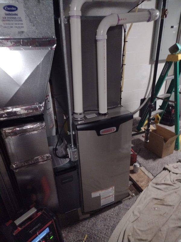 Completed full HVAC system installation including Lennox furnace with properly vented white PVC exhaust piping, heat pump system, 40-gallon residential water heater with expansion tank, and S40 programmable thermostat. Relocated air conditioning condenser unit from front to rear of property, requiring refrigerant line relocation and electrical circuit extension. All equipment installed to manufacturer specifications with proper venting, drainage, and electrical connections verified operational.