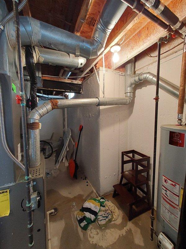 Responded to emergency call for no hot water and active water heater leak in basement affecting entire household. Upon arrival, inspected 20-year-old tanked water heater and identified catastrophic failure with active leaking at tank base, indicating internal tank corrosion and structural compromise. Given the age of the unit and severity of the leak, recommended immediate replacement rather than repair. Shut off water supply and drained existing failed unit to prevent further water damage to basement area. Disconnected all water supply lines, temperature and pressure relief valve discharge piping, and gas connections following proper safety protocols. Removed old water heater from service location in basement utility area. Installed new tanked water heater with proper clearances per manufacturer specifications and local code requirements. Connected cold water supply line with new shut-off valve, installed new flexible gas connector with proper sizing, and attached hot water distributi