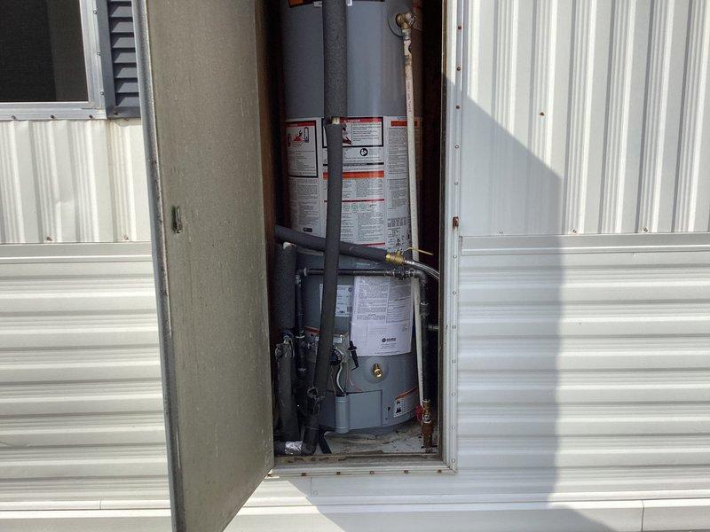 Completed installation of tanked water heater in outdoor utility closet enclosure. Installed new water heater unit with proper plumbing connections, including copper supply lines, brass fittings, and shut-off valves. Connected black piping and flexible hoses to equipment, ensuring all connections were secure and code-compliant. System tested and verified operational upon completion.