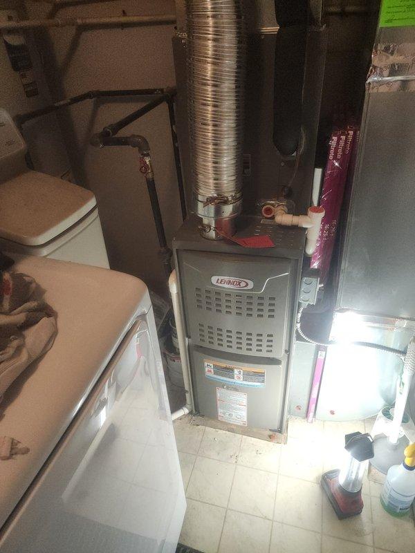 Responded to no heat call on 2-year-old Lennox furnace with pilot light repeatedly extinguishing. Upon arrival, accessed control compartment and inspected ignition system components. Found faulty flame sensor causing intermittent pilot outages and system lockouts. Removed and cleaned flame sensor rod, which showed heavy carbon buildup preventing proper flame detection. Tested ignition sequence and confirmed pilot would light but control board was not maintaining gas valve operation due to inadequate flame signal. Replaced defective flame sensor with OEM part. Verified all wire connections to control board were secure and properly seated. Cycled system through multiple heating cycles to confirm reliable ignition and consistent flame detection. Tested thermostat call for heat and verified furnace responded appropriately with no further pilot outages. System restored to full operational status with proper heating output.