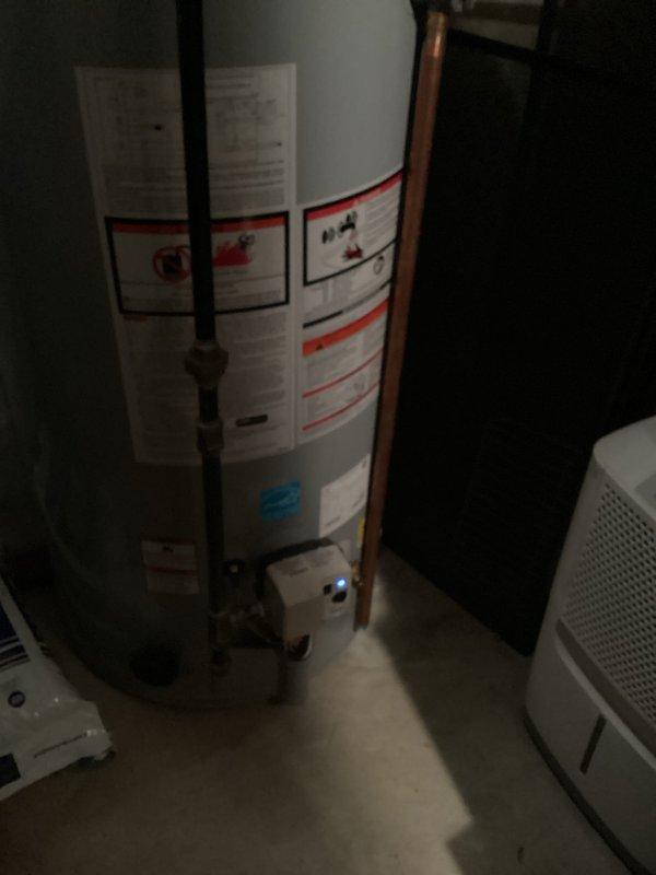 Replaced the anode rod in the residential water heater to prevent tank corrosion and extend the unit's lifespan. The existing 8-12 inch anode rod was removed from the top of the tank and a new rod was installed, ensuring proper threading and seal to maintain tank integrity and water quality.