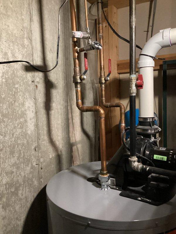 Replaced the anode rod in the residential water heater to prevent tank corrosion and extend the unit's lifespan. The existing 8-12 inch anode rod was removed from the top of the tank and a new rod was installed, ensuring proper threading and seal to maintain tank integrity and water quality.