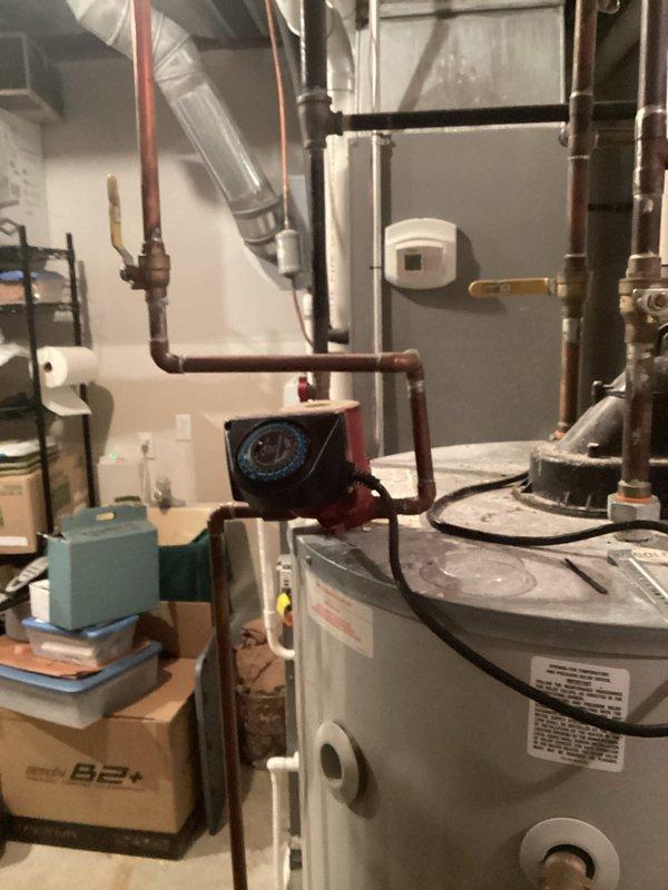 Provided estimate for replacement of 75-gallon natural draft water heater due to active leak and rust deterioration. Unit located in basement utility area with existing copper plumbing connections and red circulator pump integration. Customer requested expedited installation timeline due to no hot water condition and travel schedule constraints.