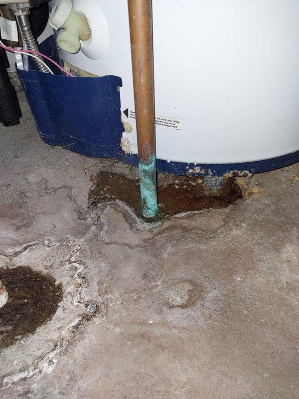 Completed routine heating maintenance on furnace system per Worry Free Service Agreement protocol. Performed comprehensive inspection of HVAC equipment, ductwork, and associated components in mechanical room. Documented existing conditions including water heater area showing floor staining and mineral deposits, corroded copper piping with green patina at base, and galvanized ductwork system with PVC condensate lines properly secured. All heating system components inspected and found operational within normal parameters for continued service.