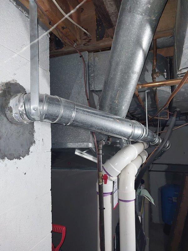 Completed routine heating maintenance on furnace system per Worry Free Service Agreement protocol. Performed comprehensive inspection of HVAC equipment, ductwork, and associated components in mechanical room. Documented existing conditions including water heater area showing floor staining and mineral deposits, corroded copper piping with green patina at base, and galvanized ductwork system with PVC condensate lines properly secured. All heating system components inspected and found operational within normal parameters for continued service.