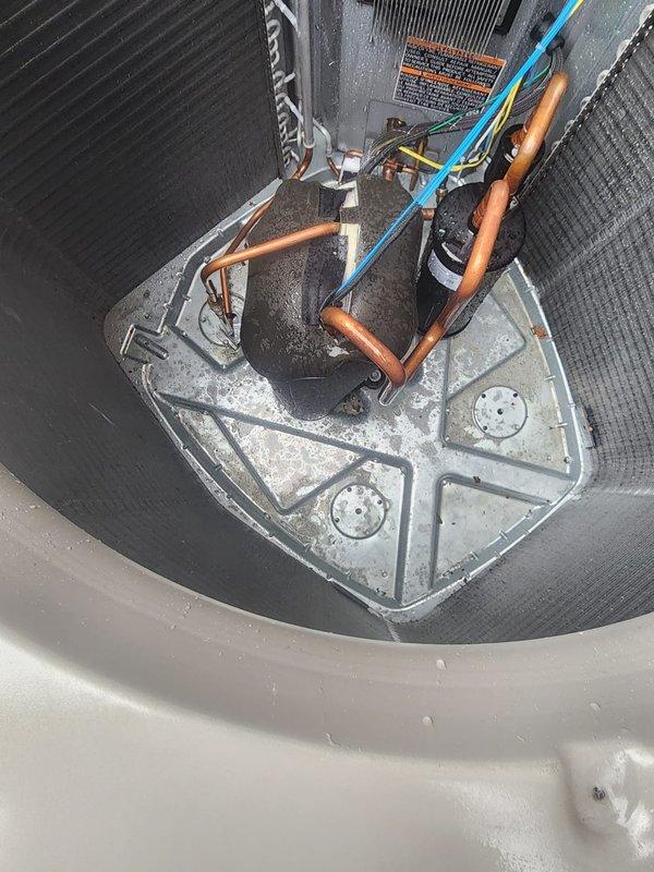 Completed scheduled preventive maintenance on residential air conditioning system. Performed comprehensive inspection of outdoor condensing unit, including examination of compressor assembly, refrigerant lines, electrical connections, and condenser coil. Unit found operating within normal parameters with copper refrigerant lines and connections in good condition, though moisture residue observed on internal mounting plate indicating normal condensation during operation.