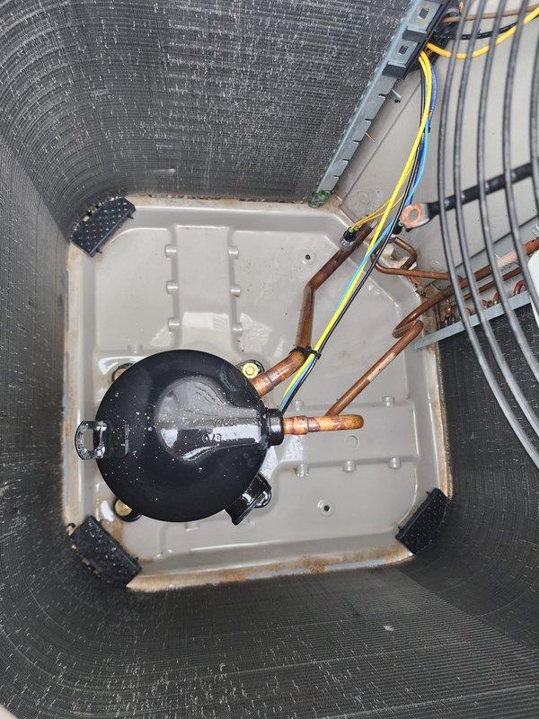 Performed annual preventive maintenance on a five-year-old residential air conditioning system located at the rear of the property. Inspection revealed heavily soiled condenser coils with significant dust and debris accumulation requiring cleaning to restore proper heat transfer efficiency. Completed comprehensive tune-up including examination of refrigerant lines, electrical connections, and compressor operation, with photographic documentation of unit condition before servicing.