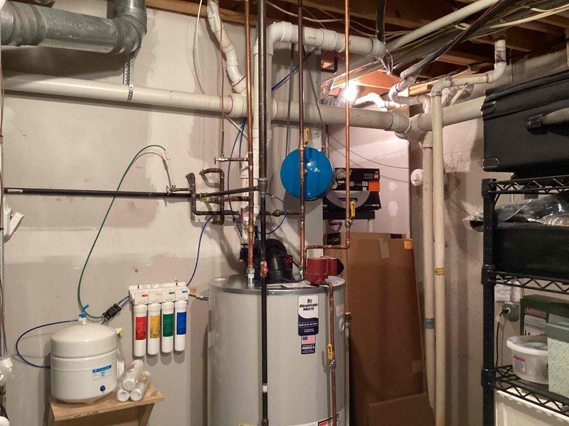 Installed 75-gallon tanked water heater in basement utility room, connecting all necessary water supply lines and ensuring proper integration with existing plumbing infrastructure. Reconnected and tested circulating pump to restore hot water circulation throughout the system, verifying all connections for proper operation and leak-free performance.