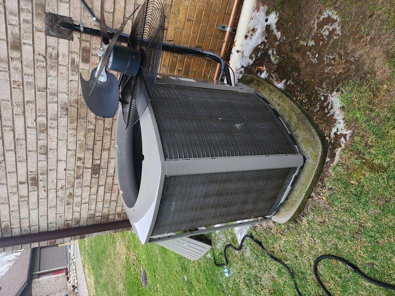 Completed routine cooling system tune-up and maintenance on residential HVAC system. Inspected indoor air handler components including condensate drain pan, condensate pump, refrigerant lines, and filter assembly; noted significant soiling and rust staining in drain pan indicating need for future cleaning attention. Serviced outdoor condenser unit, verified proper operation of compressor and fan motor, confirmed system cooling functionality and left unit in working condition.