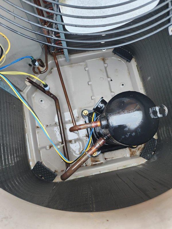 Completed comprehensive tune-up and maintenance on a 10-year-old residential air conditioning system located on the main floor. Performed thorough inspection of outdoor condenser unit, which showed significant dirt and debris accumulation on exterior ventilation fins and coils requiring cleaning. Inspected internal components including compressor, copper refrigerant lines, electrical connections, capacitor, and condenser fan motor, all of which were found to be in operational condition. Addressed the reported condenser pump concern through detailed system evaluation. Documented equipment condition with photographs showing normal wear patterns consistent with outdoor installation and age of unit.