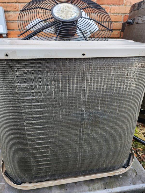 Completed comprehensive tune-up and maintenance on a 10-year-old residential air conditioning system located on the main floor. Performed thorough inspection of outdoor condenser unit, which showed significant dirt and debris accumulation on exterior ventilation fins and coils requiring cleaning. Inspected internal components including compressor, copper refrigerant lines, electrical connections, capacitor, and condenser fan motor, all of which were found to be in operational condition. Addressed the reported condenser pump concern through detailed system evaluation. Documented equipment condition with photographs showing normal wear patterns consistent with outdoor installation and age of unit.