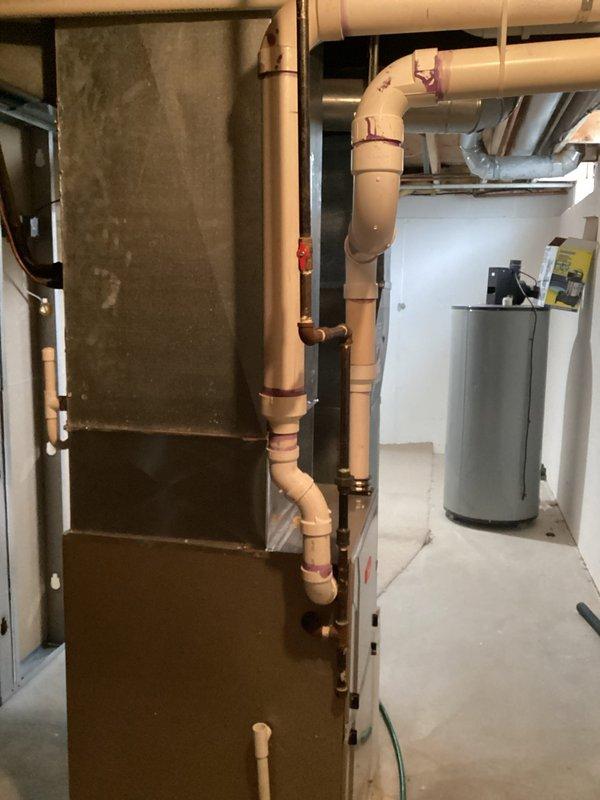 Conducted comprehensive HVAC system evaluation for equipment replacement estimate at residential property. Assessed existing outdoor air conditioning condenser unit with cylindrical design and protective mesh grille, currently positioned on concrete pad with proper clearance and electrical disconnect box installation. Evaluated indoor furnace system located in basement mechanical area, noting current configuration with existing condensate drainage system, PVC piping, and ductwork connections. Provided detailed equipment replacement recommendations featuring Bryant brand HVAC systems per customer preference, documenting current system specifications and proposing appropriate sizing and efficiency ratings for complete heating and cooling system replacement.