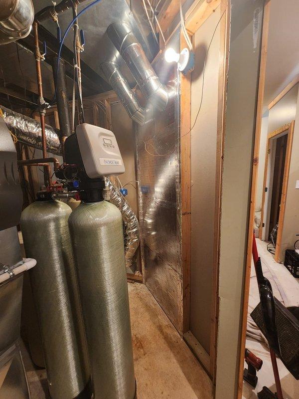 Installed new return air vent in basement utility area to improve HVAC system airflow and circulation. Ran ductwork through existing mechanical room, integrated with current duct system, and mounted white return grille near baseboard on finished wall. Installation completed successfully with all components properly secured and operational.