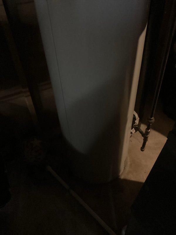 Conducted on-site evaluation and prepared detailed estimate for water heater replacement in residential basement utility area. Assessed existing white cylindrical tank water heater with atmospheric venting system, including inspection of metallic flue pipe, ductwork connections, and surrounding copper supply plumbing infrastructure. Documented current installation conditions, clearances, and access points for future replacement work. Photographed existing unit configuration, piping connections at tank base, and ventilation system routing to support accurate material specifications and labor requirements for upcoming installation.