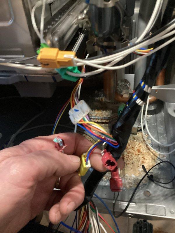 Responded to no hot water complaint on tankless water heater unit. Upon inspection, identified faulty wiring connection in the control board assembly. Disconnected and reconnected multi-wire harness connector to restore proper electrical continuity, tested unit operation, and confirmed hot water delivery restored to normal function.