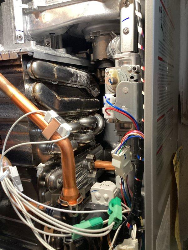 Responded to no hot water complaint on tankless water heater unit. Upon inspection, identified faulty wiring connection in the control board assembly. Disconnected and reconnected multi-wire harness connector to restore proper electrical continuity, tested unit operation, and confirmed hot water delivery restored to normal function.