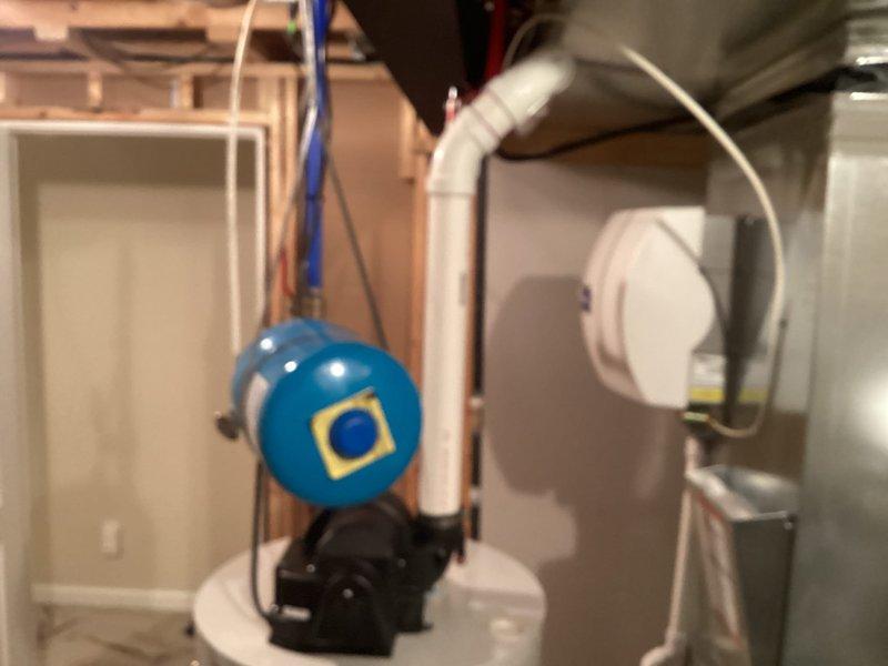 Installed 50-gallon tanked water heater in basement utility room to serve residential hot water needs for 1-3 occupants. Connected copper supply lines with shut-off valves, installed pressure relief valve with discharge piping, and integrated blue pressure tank with pump assembly to maintain consistent water pressure throughout the system. Verified all connections for proper operation and leak-free performance.