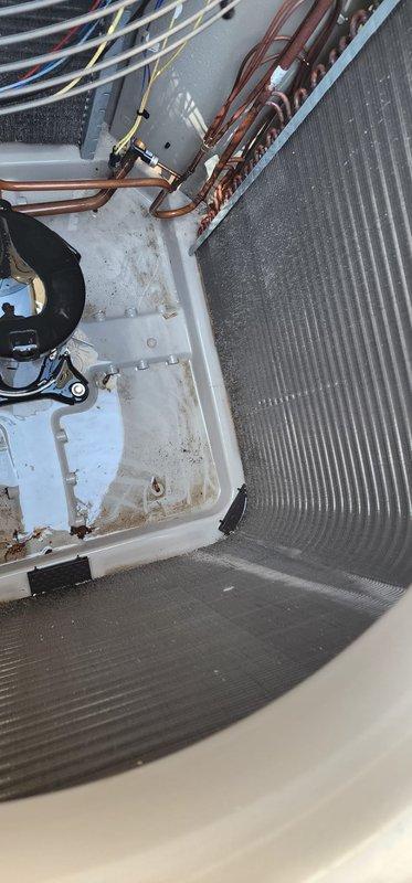 Completed comprehensive AC maintenance service including inspection of indoor evaporator coil and outdoor condensing unit. Inspected drain pan showing normal operational wear and accumulation, verified proper drainage function, and examined copper refrigerant lines for secure connections. Evaluated outdoor condenser unit with attention to coil fins and overall system condition, confirmed unit operational status and proper airflow through heat exchanger components.