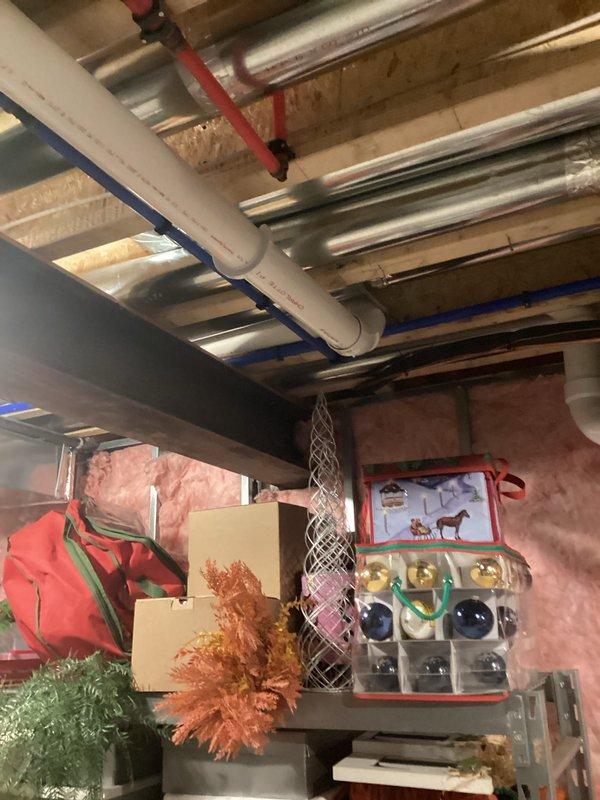 Conducted on-site assessment for tankless water heater installation in residential basement utility area. Evaluated existing plumbing infrastructure including copper supply lines, PVC drainage system, pressure tank configuration, and circulating pump setup to determine feasibility and requirements for converting from traditional tank system to tankless unit. Documented current mechanical room layout, overhead joist clearances, gas line accessibility, venting pathways through existing ductwork areas, and electrical service capacity for proper equipment specification and installation planning.