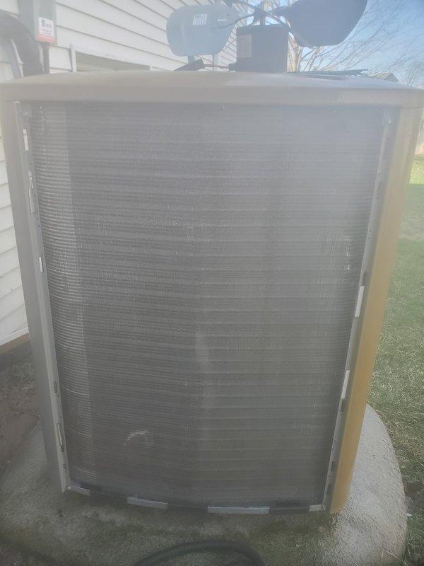Completed routine cooling system maintenance and tune-up on residential HVAC unit. Inspected outdoor condenser unit, noting accumulated dust and debris on heat exchanger fins; cleaned condenser coils to restore optimal airflow and heat transfer efficiency. Examined indoor evaporator coil assembly, motor, and refrigerant lines; verified all electrical connections, tested system operation, and confirmed unit is functioning properly with no issues detected.