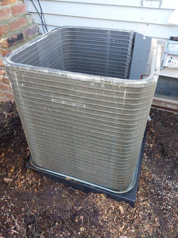 Completed scheduled cooling system maintenance and tune-up on residential outdoor condenser unit. Performed comprehensive inspection of heat exchanger coils, compressor, refrigerant lines, and electrical connections. Documented equipment condition with photos showing aluminum fin coil with accumulated debris, black cylindrical compressor with copper refrigerant lines, and associated wiring secured with proper bundling. All components found operational with system working properly. Verified proper compressor mounting, refrigerant line connections, and electrical wiring integrity. Unit showing normal wear consistent with regular use, including minor dirt accumulation on fins and weathering on base plate. System confirmed operational and left in working condition.