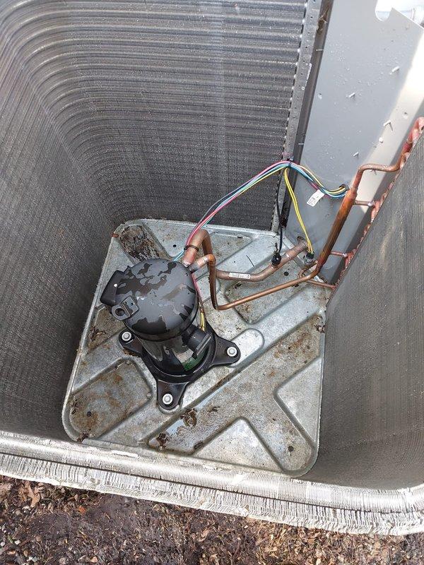 Completed scheduled cooling system maintenance and tune-up on residential outdoor condenser unit. Performed comprehensive inspection of heat exchanger coils, compressor, refrigerant lines, and electrical connections. Documented equipment condition with photos showing aluminum fin coil with accumulated debris, black cylindrical compressor with copper refrigerant lines, and associated wiring secured with proper bundling. All components found operational with system working properly. Verified proper compressor mounting, refrigerant line connections, and electrical wiring integrity. Unit showing normal wear consistent with regular use, including minor dirt accumulation on fins and weathering on base plate. System confirmed operational and left in working condition.