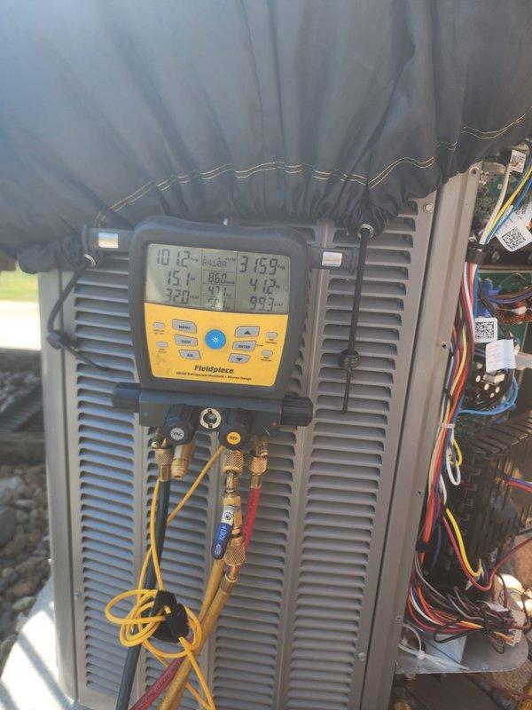 Performed comprehensive air conditioning maintenance on outdoor condensing unit. Connected digital gauge manifold to measure system pressures and temperatures, verified refrigerant charge levels and operating parameters within manufacturer specifications. Removed access panel to inspect internal electrical components, wiring connections, and contactors for proper operation and secure termination.