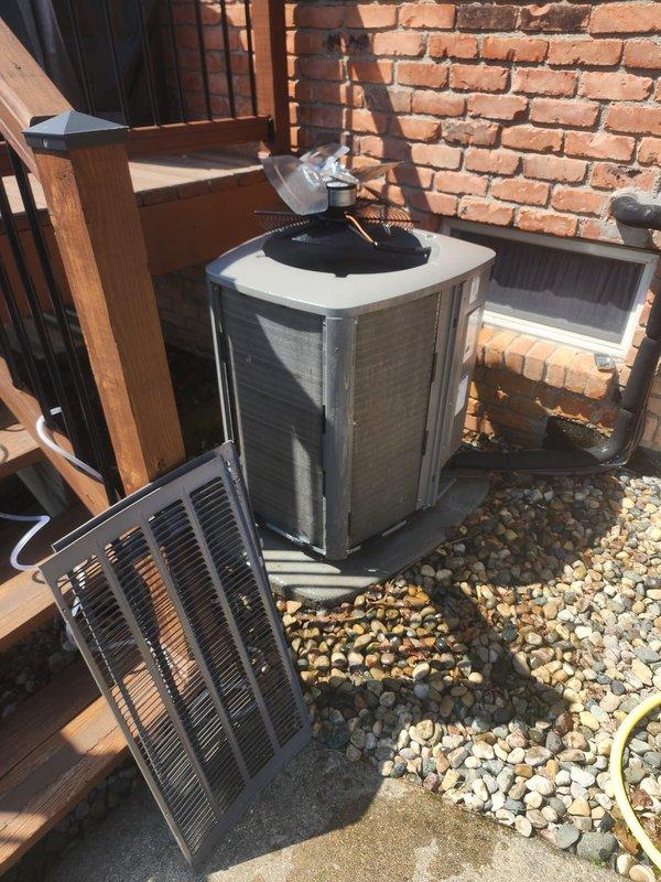 Performed comprehensive air conditioning maintenance on outdoor condensing unit. Connected digital gauge manifold to measure system pressures and temperatures, verified refrigerant charge levels and operating parameters within manufacturer specifications. Removed access panel to inspect internal electrical components, wiring connections, and contactors for proper operation and secure termination.