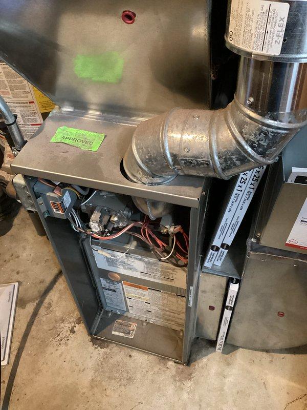 Completed scheduled preventive maintenance on residential forced-air furnace system. Performed comprehensive inspection of heating unit, verified proper operation of all components including burners, heat exchanger, blower motor, and control board. Cleaned and serviced equipment, checked gas connections, tested safety controls, and documented system condition with photographic records showing unit with access panel removed for internal inspection and overall installation configuration.