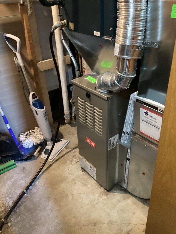 Completed scheduled preventive maintenance on residential forced-air furnace system. Performed comprehensive inspection of heating unit, verified proper operation of all components including burners, heat exchanger, blower motor, and control board. Cleaned and serviced equipment, checked gas connections, tested safety controls, and documented system condition with photographic records showing unit with access panel removed for internal inspection and overall installation configuration.
