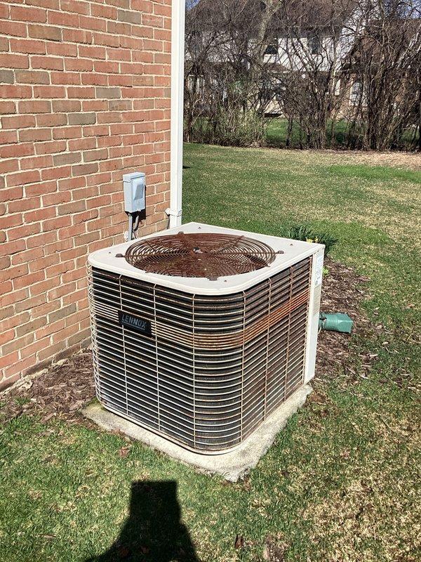 Conducted comprehensive assessment of residential HVAC system for replacement estimate. Evaluated 1997 outdoor condensing unit positioned on concrete pad adjacent to building exterior, noting system age and refrigerant depletion. Documented existing indoor air handler installation in basement mechanical room, including current PVC condensate drainage configuration and equipment mounting. Provided detailed replacement recommendations for complete system upgrade due to equipment age and refrigerant loss.