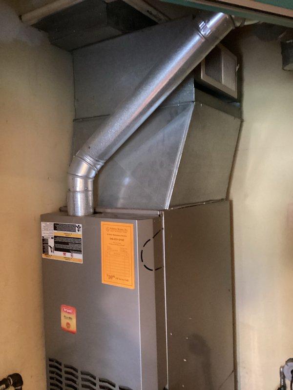 Conducted comprehensive assessment of existing 22-year-old HVAC system for replacement estimate. Inspected indoor furnace unit located in utility room accessible via side door, documenting current installation configuration including metal ductwork, exhaust piping, and ventilation components. Evaluated outdoor Bryant brand condenser unit positioned on concrete pad against exterior wall, noting weathered condition consistent with age and extended service life. Photographed both indoor and outdoor equipment to document existing system layout, accessibility constraints in compact utility space, and current operational setup. Provided detailed replacement estimate based on site conditions and equipment specifications.