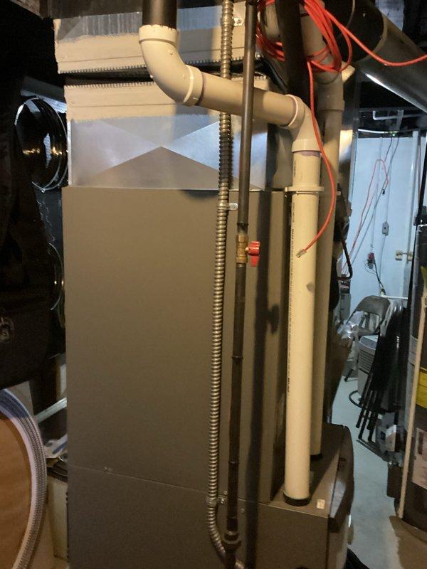 Provided comprehensive replacement estimate for aging residential HVAC system with outdoor R-22 condenser unit dating from 1996 that was found to be low on refrigerant. Assessment included evaluation of both the exterior condensing unit with deteriorating heat exchanger coils and the interior furnace installation, documenting current system condition through detailed photography to support recommendations for complete system replacement due to obsolete refrigerant type and equipment age exceeding typical service life.