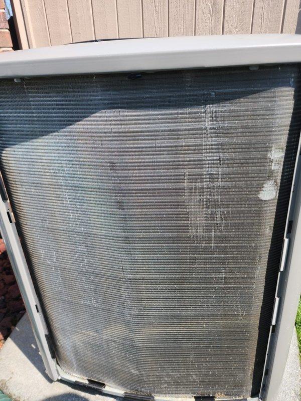 Completed annual preventative maintenance inspection on 3-year-old outdoor air conditioning system under Worry Free Service Agreement. Performed comprehensive tune-up including visual inspection of condenser unit, coils, refrigerant lines, and electrical connections. Documented pre-service condition showing dust and debris accumulation on condenser mesh screen and exterior components, with photographic evidence of equipment condition and mechanical assembly for maintenance records.