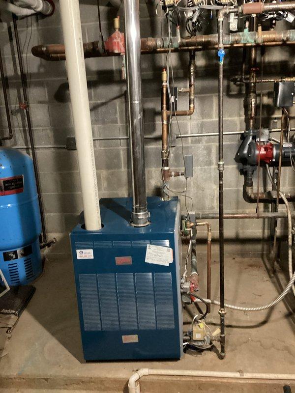 Performed system startup on newly installed blue boiler unit and heating equipment in mechanical room. Verified proper operation of circulator pump, zone valves, and hydronic piping network with copper and black pipe configurations. Conducted heating maintenance on pre-existing furnace unit, inspecting blower motor assembly, electrical connections, and control boards. All systems tested and confirmed operational with no deficiencies noted.