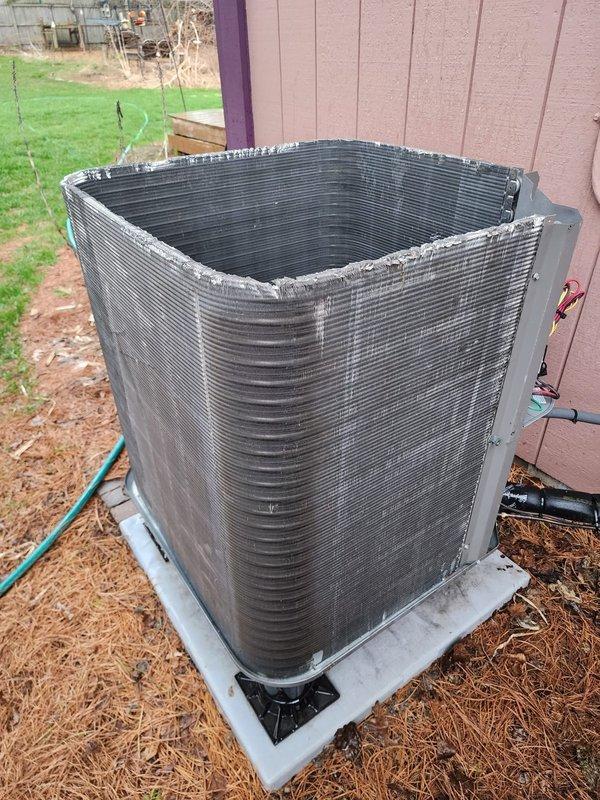 Completed scheduled air conditioning maintenance on outdoor condenser unit and associated indoor components. Performed visual inspection of exterior condenser, noting unit operational with normal wear consistent with age. Verified condenser pad level and stable on concrete foundation. Inspected electrical connections and refrigerant line sets running to building exterior. Accessed indoor air handler, inspecting condensate drain pan and pump assembly. Observed mineral deposits and staining on drain pan indicating normal condensation activity. Verified condensate pump mounting secure and drain lines properly connected. All system components found operational during maintenance inspection.