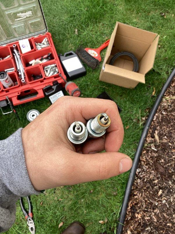 Completed routine generator maintenance service including spark plug inspection and replacement. Removed and examined existing spark plugs, which showed normal wear patterns consistent with regular operation. Installed new spark plugs to manufacturer specifications, ensuring proper gap settings and torque values. Verified generator air intake screen was clear of debris and functioning properly to maintain adequate ventilation for safe operation.