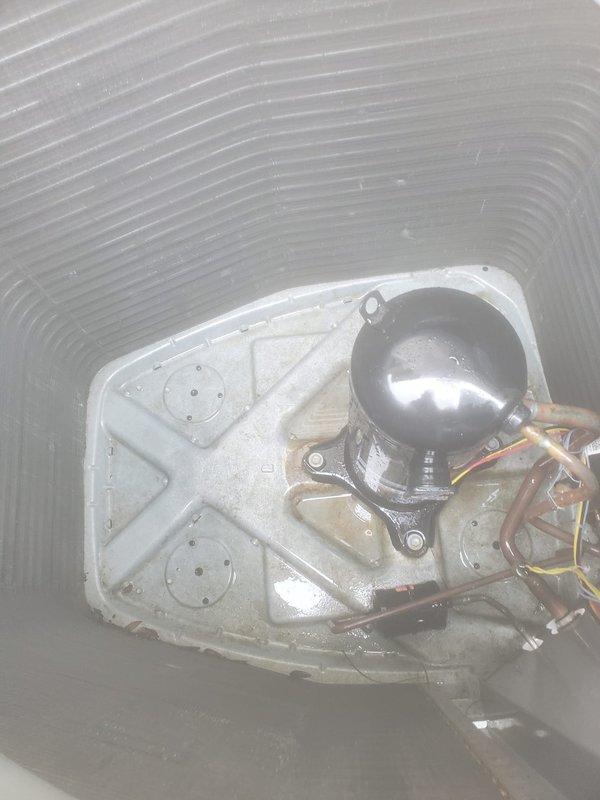 Completed comprehensive preventive maintenance on 12-year-old air conditioning system located at rear of property. Performed full AC tune-up including inspection of compressor assembly, refrigerant lines, and electrical connections; verified proper operation of condensing unit and examined condenser coil for airflow efficiency. All components inspected and found operating within normal parameters; unit showing typical wear for age with minor dust accumulation on coil fins, no immediate repairs required at this time.