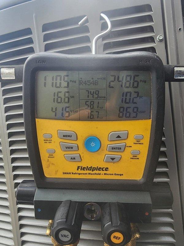 Performed system start-up on air conditioning unit following installation. Connected refrigerant manifold gauges and verified system pressures, recording 170.5 PSIA on low side and 240.6 PSIA on high side. Identified damaged insulation on ductwork with significant horizontal tear exposing interior surface, which will require repair to maintain system efficiency and prevent condensation issues.