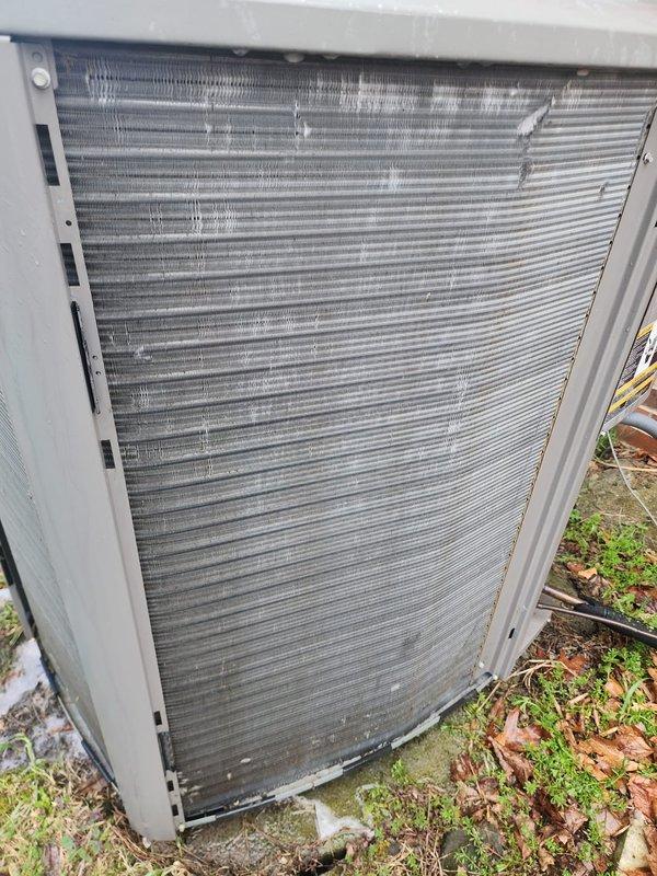 Completed comprehensive AC maintenance on outdoor condensing unit. Inspected condenser coil fins, compressor, electrical connections, and mounting components. Unit operational with all wiring and mechanical components functioning properly.