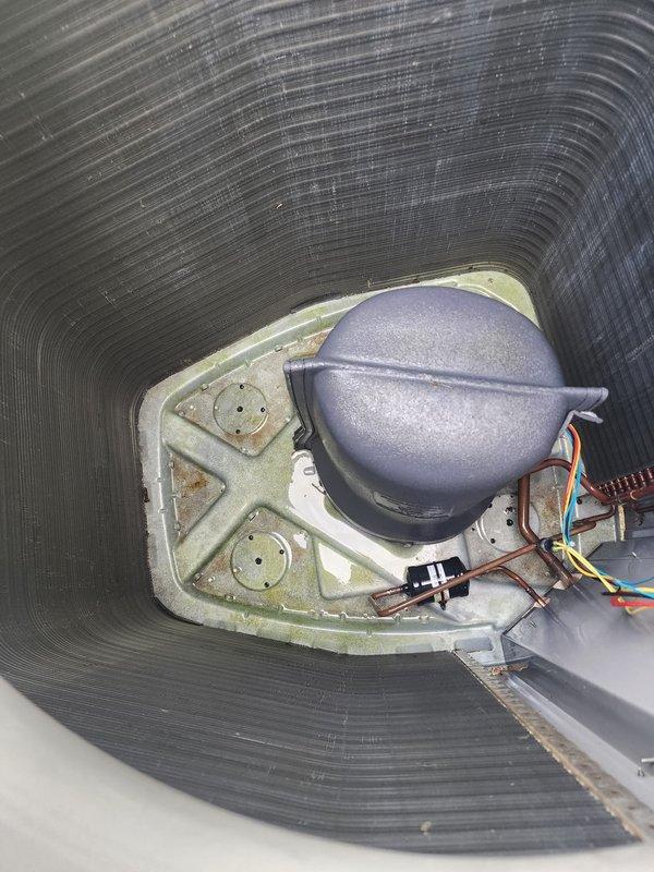 Completed comprehensive AC maintenance on outdoor condensing unit. Inspected condenser coil fins, compressor, electrical connections, and mounting components. Unit operational with all wiring and mechanical components functioning properly.